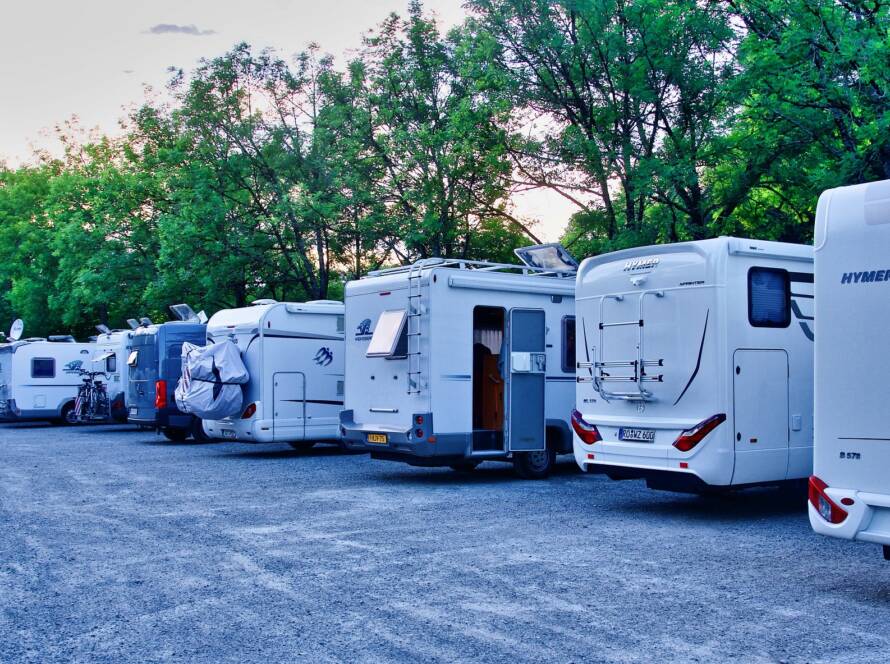 RV motorhomes lined up at a campsite